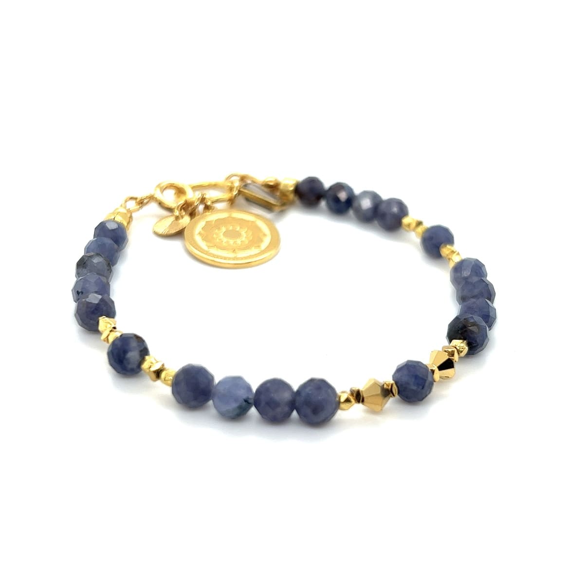 Bransoletka Tanzanit Bogini Wyzwolenia od Ewa Mrochen Jewellery, z niebieskimi kamieniami na delikatnym łańcuszku.