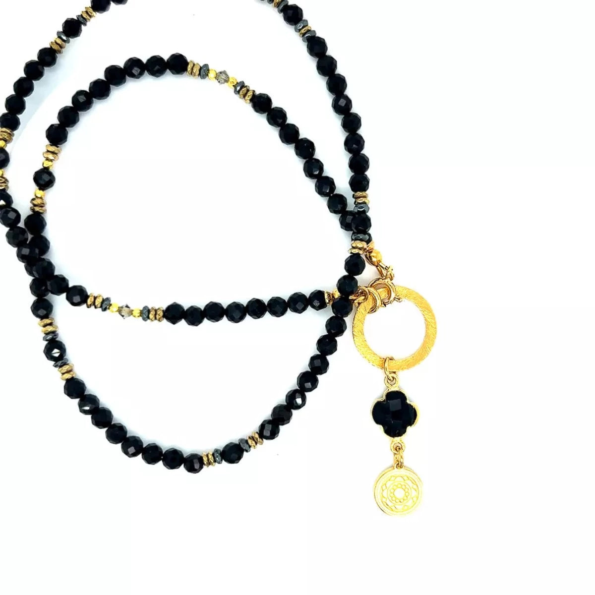 Czarny turmalinowy naszyjnik Ewa Mrochen Jewellery z kamieniem, symbol ochrony i elegancji, na czarnym tle.